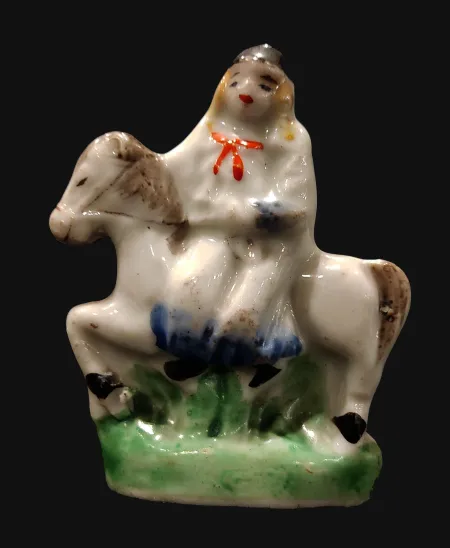 A Porcelain Figure of a Girl Sits  on a White Horse